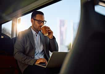 man on bus drinking coffee