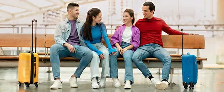 Travelers sit in an airport terminal